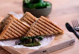 Toasted Serrano ham sandwich with Aged Havarti and PadrĂ³n peppers